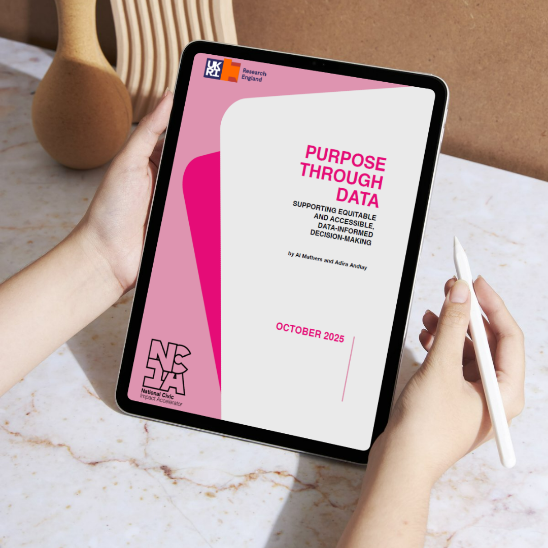 person holding a tablet and pen. Tablet screen displays NCIA report titled 'Purpose Through Data' subheading - supporting equitable and accessible, data-informed decision-making. By Al Mathers and Adira Andlay